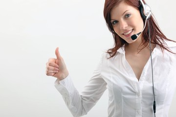 young woman with headset and thumb up