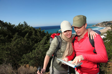 Couple looking at map on a hiking day