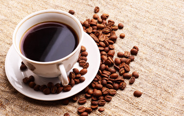 Coffee cup and grain onon a fabric. Still-life