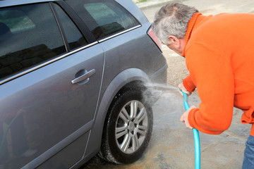 Senior man washing his car