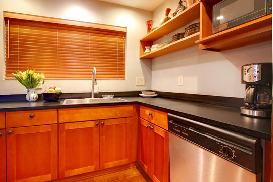 Modern cherry luxury kitchen with black ans stain steal.
