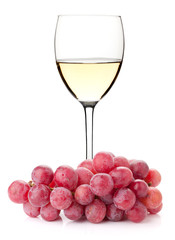 White wine in glass with red grape branch