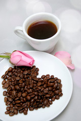 Cup of coffee with heart from coffee beans