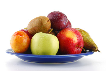 Variety of fresh fruits on blue plate