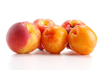 Fresh fruits isolated on white. Plums and peach