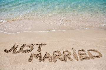 Just married written on the sand