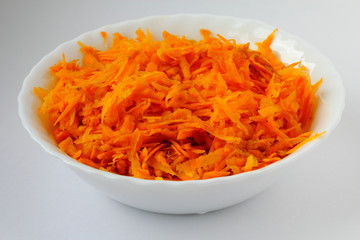 Carrot in the white soup plate