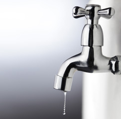 metal tap with water drop