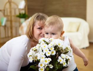 Obraz na płótnie Canvas little boy with flowers
