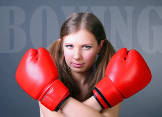 Woman boxing punching red gloves