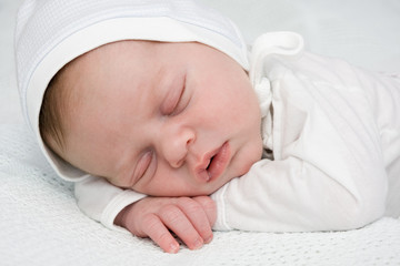 Newborn boy sleeping in cap