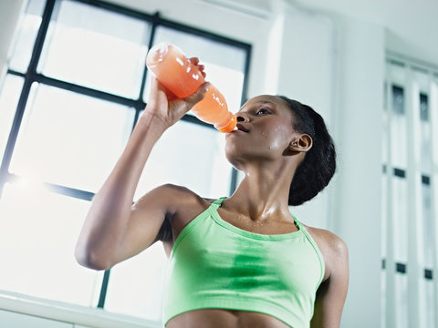 African Woman In Gym Drinking Energy Drink