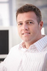 Portrait of middle-aged office worker smiling