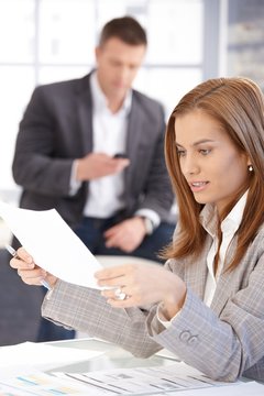 Young female working with papers in office