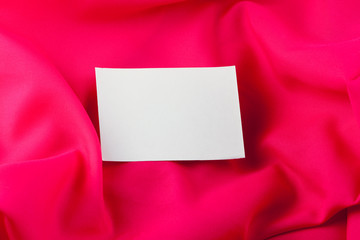 White paper note on red silk