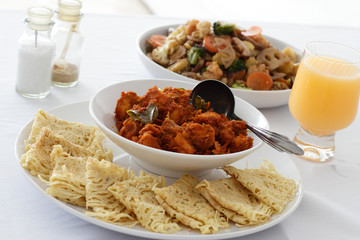 A dish of Rendang chicken with Roti Jala