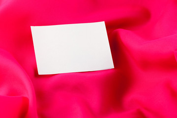 White paper note on red silk