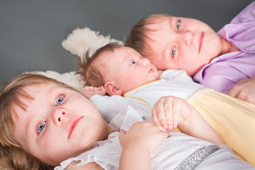 Fototapeta na wymiar Portrait of three children on a gray background