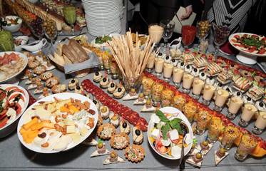 Great number of snacks on banquet table