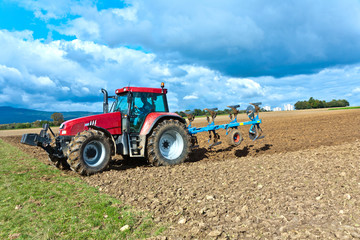 Fototapeta premium tractor working at the field