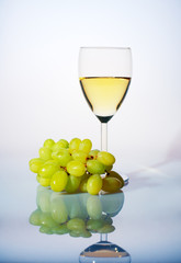 Glass of white wine and grapes