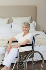 Smiling senior woman in her wheelchair