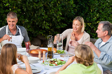 Lovely family eating in the garden