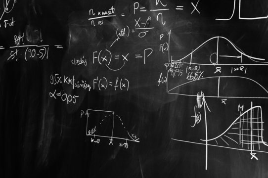 black and white picture of a chalk board with formulas