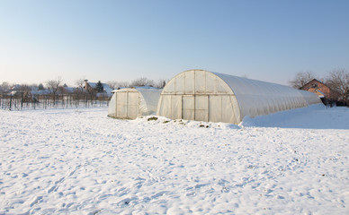 plastic hothouse in winter garden