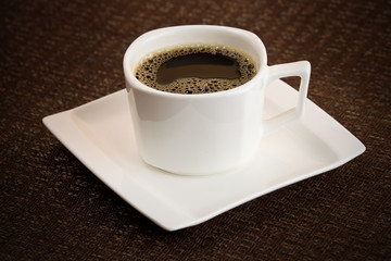 Simple dark coffee cup with brew
