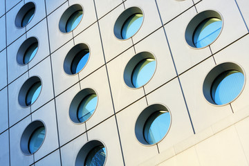 Windows of modern building toned in blue color