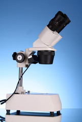 Medical microscope on blue background