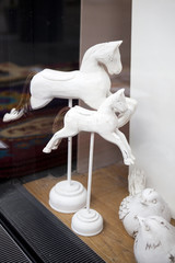 wood white bird and horse sitting on window shell