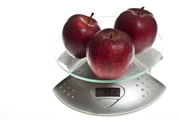 Red apples on food scale