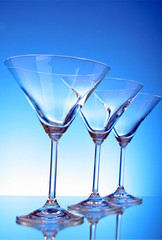 empty glasses of martini on the light blue background