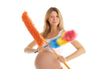 happy pregnant woman with a mop and brush