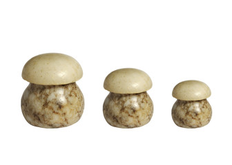 Fototapeta na wymiar Three statuettes of stone mushrooms isolated on white