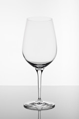 empty wine glass with reflection on white