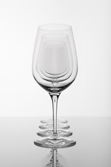 row of four empty wine glasses