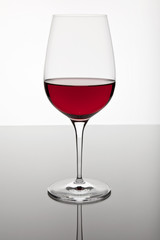 Glass of red wine on a bright background