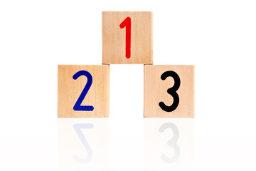 number 123 from letter wooden blocks as a podium