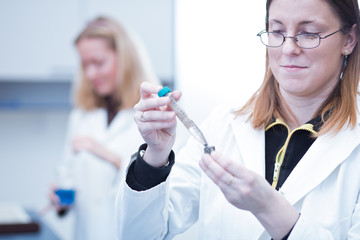 Two female researchers carrying out research in a chemistry/bioc