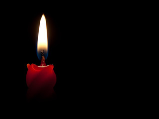 Burning candle black background
