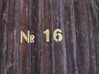 number sixteen painted on a old wood texture