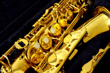 golden shiny saxophone on black background