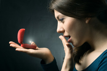 Jewelry in the open case and admired woman. © papa