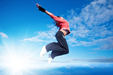 Fototapeta na wymiar sport woman jumping and fly over sky and sun