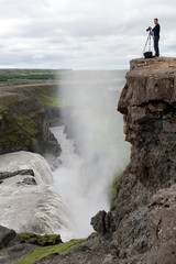 photographer posing above Gullfoss waterfall, Iceland