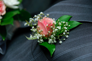red rose on a groom coat