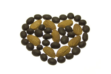 Heart shape made of almonds and chocolate balls